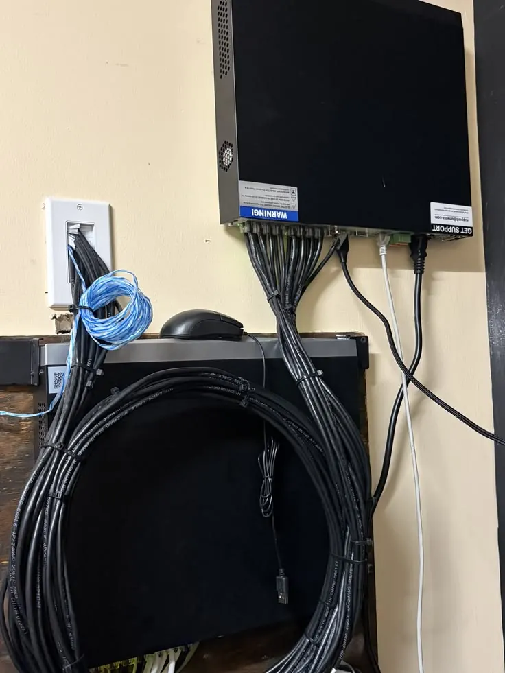 NVR on the wall with neatly bundled cables